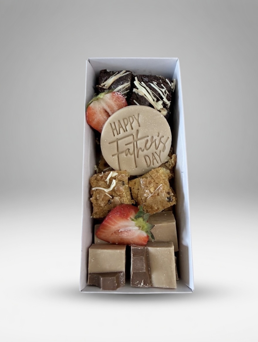 Gift box of assorted chocolates with strawberries and a round 'Happy Father's Day' disk at the center